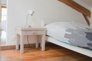 a bedroom with a bed and a nightstand with a lamp at Maison Entière à Cébazat in Cébazat