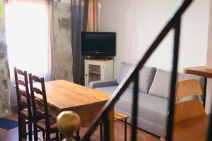 a living room with a couch and a table and a television at Maison Entière à Cébazat in Cébazat