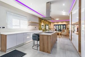 a kitchen with white cabinets and a island with a stove at Braham Lodge - The Octave 5 in Johannesburg