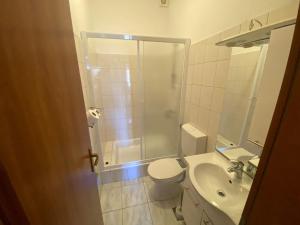 a bathroom with a shower and a toilet and a sink at Apartment Joso in Primošten +58 photos