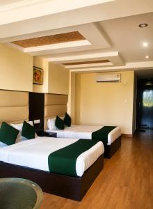 a hotel room with two beds in a room at Hotel Rio Haridwar in Haridwār