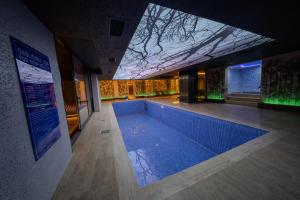 a swimming pool in the middle of a building at Tryp By Wyndham Istanbul Sancaktepe in Istanbul