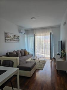 a living room with a couch and a table at Apartments Bujkovic in Bar