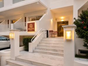 a house with stairs and a sign that reads q infinity at Melitti Lucent in Rethymno