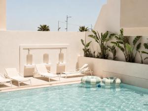 a pool with lounge chairs and a swimming pool at Melitti Lucent in Rethymno +14 photos