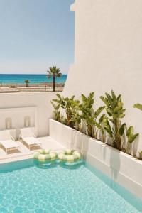 a pool with a view of the beach and the ocean at Melitti Lucent in Rethymno