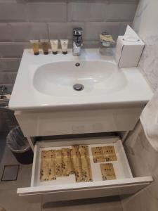 a white sink in a bathroom with a drawer at Hawana Studio SL-3 in Wādī Khasbar
