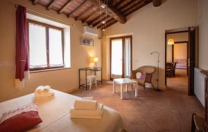 a bedroom with a bed and a living room at La Casina dei Lapi in Catabbio