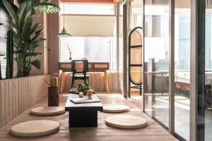 a dining room with a table and four chairs at INVIS Urban High-rise Suites in Chengdu +287 photos