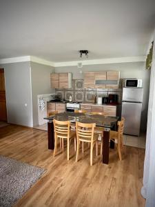 a kitchen with a table and chairs in a room at Vormsi Ohvitseride Maja korter nr 2 in Hullo