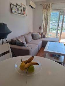 a plate of bananas and fruit on a table in a living room at Aska Apartment in Bar