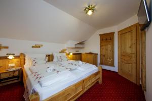a bedroom with a large bed with christmas decorations on it at Panorama Hotel Leidingerhof in Mondsee
