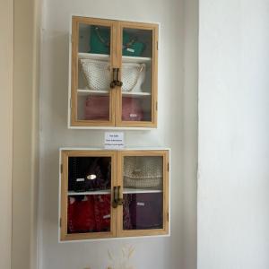 two wooden cabinets with dishes inside of it at Marys Central Beachside Mansion in Agios Nikolaos