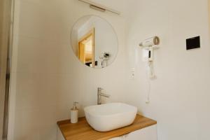 a white bathroom with a sink and a mirror at Sokoli Zakątek - domki w Bieszczadach in Bukowiec +30 photos