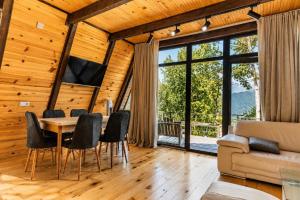 a living room with a table and chairs and a couch at Hatsvali Gate in Mestia