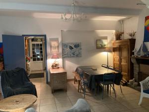 a living room with a table and a dining room at FACE A LA MER , L ARTISTE in Ambleteuse