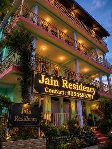 a building with a sign that reads jam residency condominium at Jain Residency in Manāli