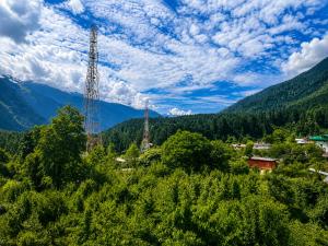 a view of a valley with trees and mountains at Jain Residency in Manāli
