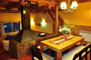 - un salon avec une table et une cuisinière dans l'établissement Hotel y Cabañas del Nevado, à Caviahue