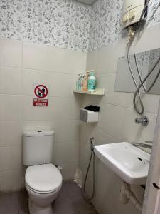 a bathroom with a toilet and a sink at Moustachz Hauze , Georgetown in George Town