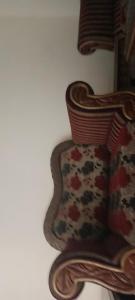 a close up of a wooden chair with a pillow at Home in Faisalabad