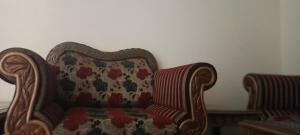a chair sitting in a room next to a wall at Home in Faisalabad