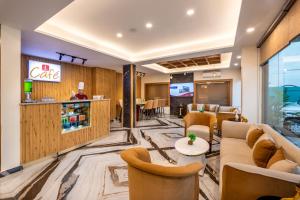 a lobby of a hotel with couches and chairs at Lords Inn Katra in Jāmb