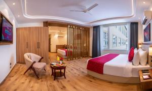 a hotel room with a bed and a table at Lords Inn Katra in Jāmb +44 photos