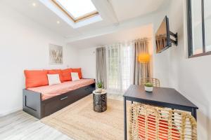 a living room with a couch and a fireplace at Bright studio - RER B - Plateau de Saclay in Palaiseau