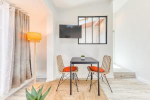 a dining room with a table and two chairs at Bright studio - RER B - Plateau de Saclay in Palaiseau