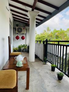 a tea pot on a table on a balcony at Judewin villa Negombo in Negombo