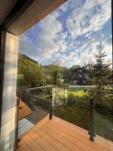 a view from the balcony of a house with a deck at Willa Folc in Kościelisko