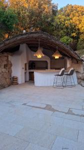 a patio with two chairs in front of a building at Stazzu La Vigna Di Maria in Aglientu
