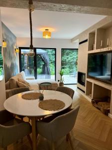 a living room with a white table and chairs at Leśny Azyl Rzeszów in Hermanowa