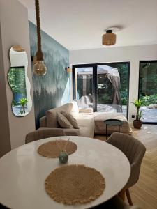 a living room with a table and a couch at Leśny Azyl Rzeszów in Hermanowa