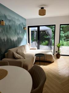 a living room with a couch and a table at Leśny Azyl Rzeszów in Hermanowa