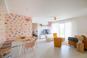 a living room with a table and a dining room at Bright House between Ocean and Golf in Moliets-et-Maa +14 photos