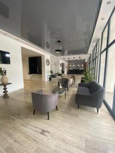 a lobby with couches and chairs in a building at Hotel Unirea in Mamaia
