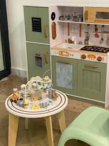 a toy kitchen with a table with a toy stove at Hotel Unirea in Mamaia
