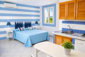 a blue and white bedroom with a bed and a sink at Maridea - Ondine in Ponza +58 photos
