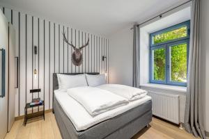 a bedroom with a bed with a deer head on the wall at Residenz Boutique Suites in Bad Gastein