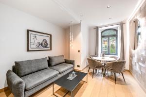 a living room with a couch and a table at Residenz Boutique Suites in Bad Gastein