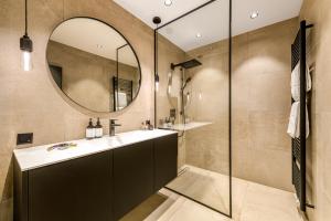 a bathroom with a sink and a mirror at Residenz Boutique Suites in Bad Gastein +93 photos