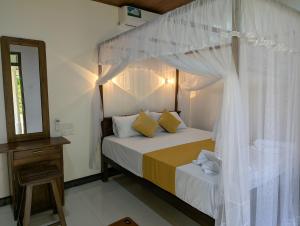 a bedroom with a bed with a canopy at Randiwa Homestay in Sigiriya