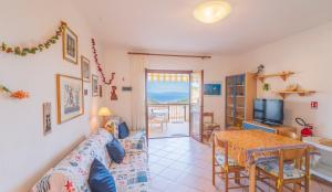 a living room with a couch and a table at Appartamento Vista Nel Mare Blu in Rio nellʼElba