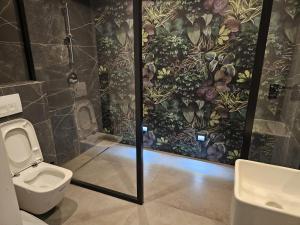 a bathroom with a toilet and a wall mural at Apartament Pruszcz Gdański 1 in Pruszcz Gdański