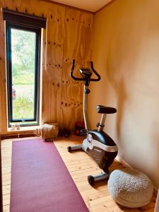 a room with a treadmill and a room with a window at Nykmark Eco Residence in Unnstad