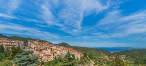a town on a hill with houses on it at Appartamento Vista Nel Mare Blu in Rio nellʼElba