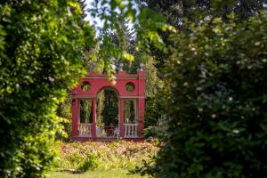 a red house in the middle of a garden at Mas de la Chapelle in Arles