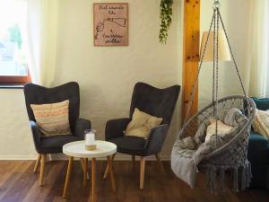 a living room with two chairs and a table at Eifel Moments in Kall